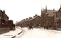 Image of Bede Burn Road Jarrow, in the 1925-1930, looking south. Note the twin spires of the Park Methodist Church down the street on the right.